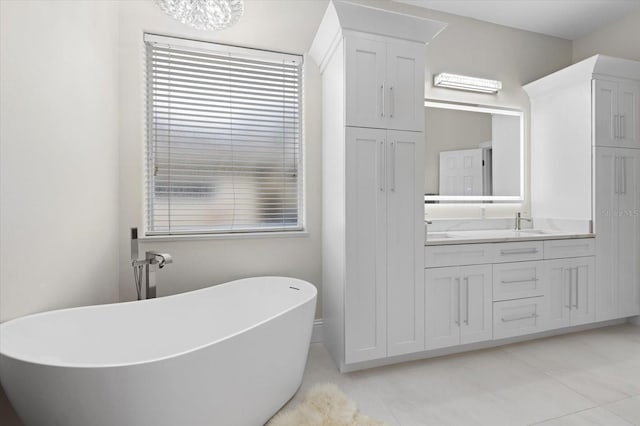 bathroom featuring a bathing tub, vanity, and tile patterned floors