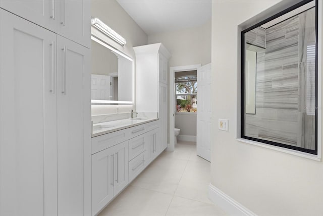 bathroom with tile patterned flooring, vanity, and toilet