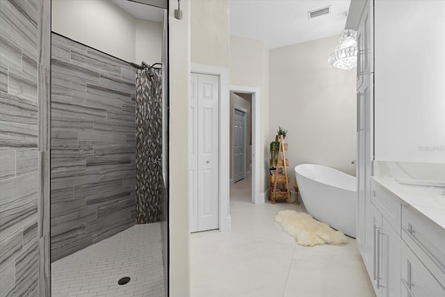 bathroom with tile patterned flooring, vanity, and separate shower and tub