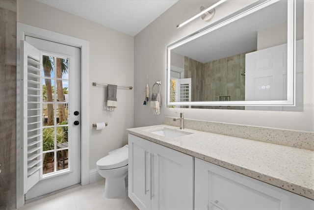 bathroom featuring tile patterned floors, vanity, toilet, and walk in shower