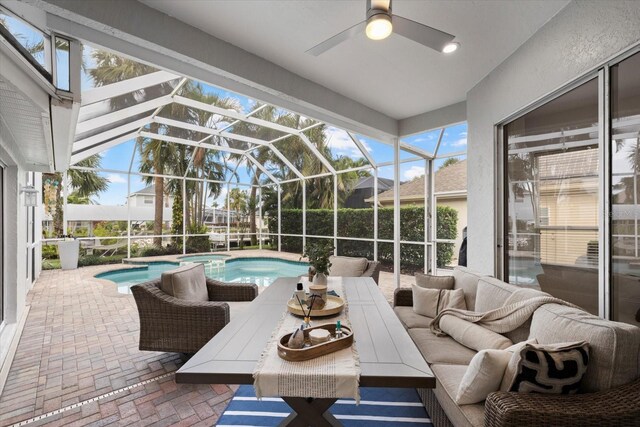 sunroom with ceiling fan and a swimming pool