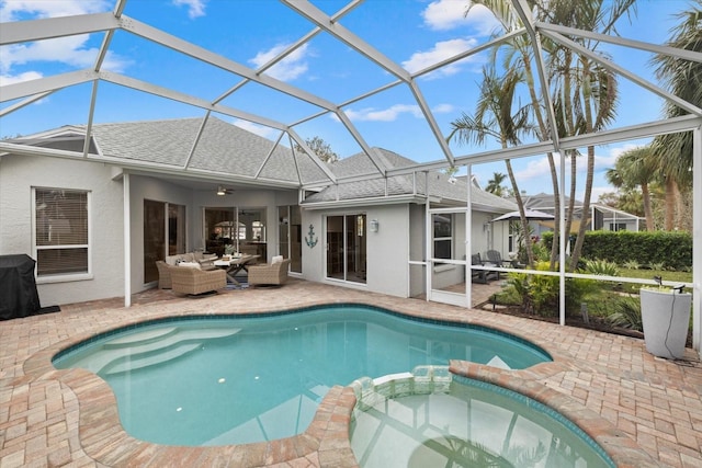 view of swimming pool featuring outdoor lounge area, a patio, glass enclosure, and ceiling fan