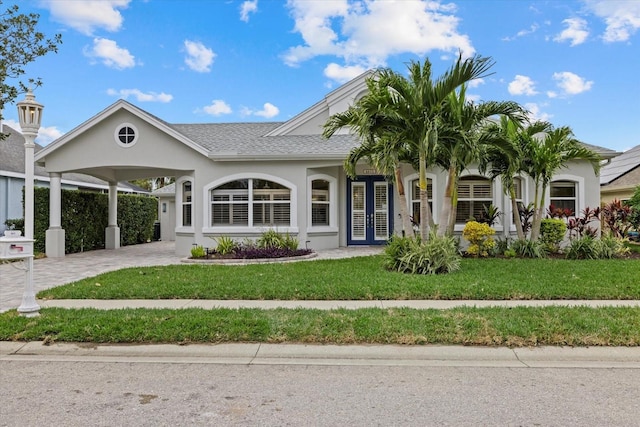 view of front facade with a carport and a front yard