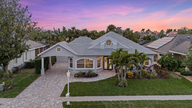 view of front of house with a lawn and a carport