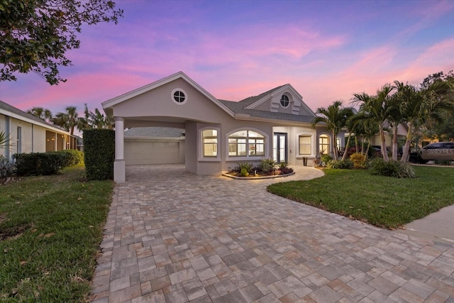 view of front of home featuring a lawn and a carport