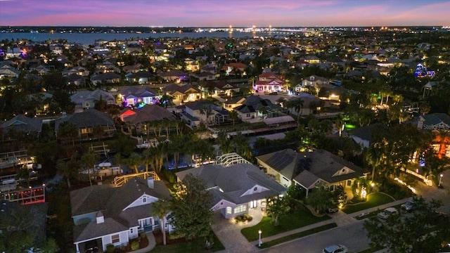 aerial view at dusk with a water view