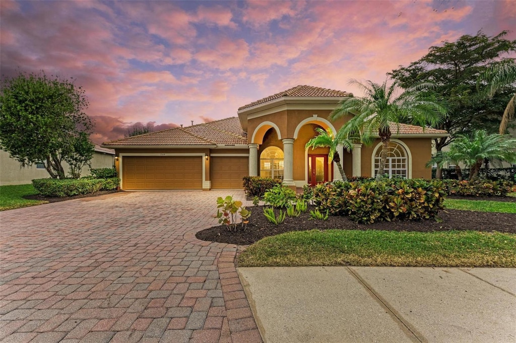 mediterranean / spanish house with a garage