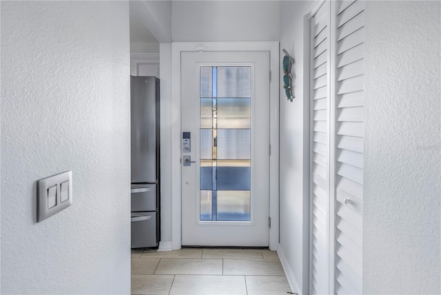 entryway with light tile patterned floors