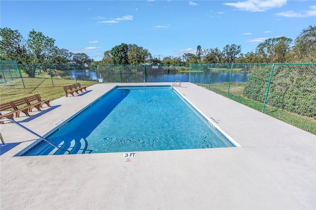 view of pool with a water view, a yard, and a patio