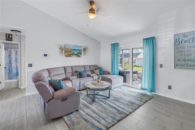 living room with ceiling fan and lofted ceiling