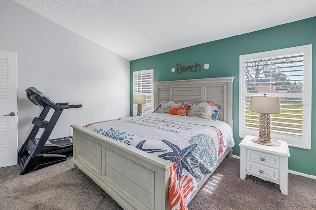 carpeted bedroom featuring a textured ceiling