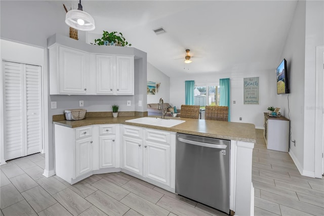 kitchen featuring sink, white cabinets, stainless steel dishwasher, and decorative light fixtures