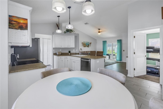 kitchen featuring white cabinetry, sink, dishwasher, kitchen peninsula, and stove