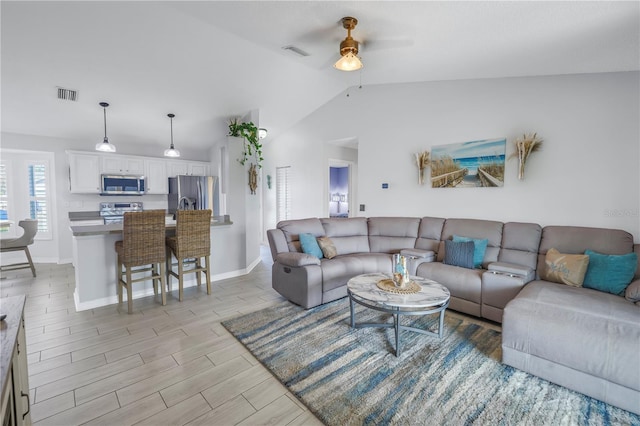 living room with ceiling fan and lofted ceiling