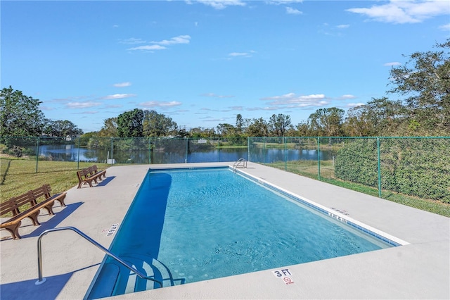 view of swimming pool with a water view