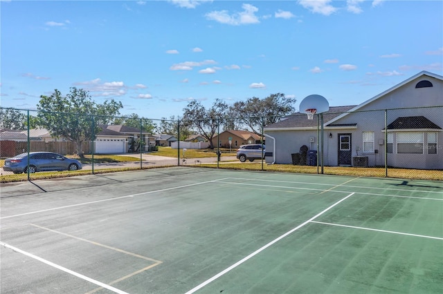 view of tennis court with basketball hoop