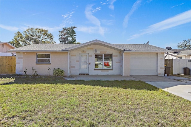 ranch-style house featuring a front yard and a garage