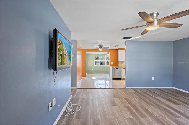 empty room featuring ceiling fan and light hardwood / wood-style floors