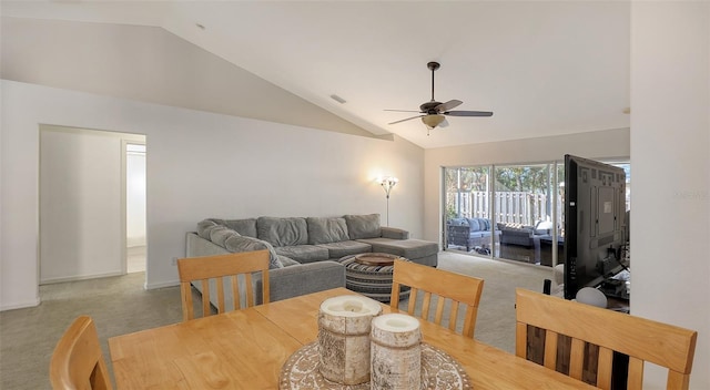 carpeted dining room featuring ceiling fan and vaulted ceiling