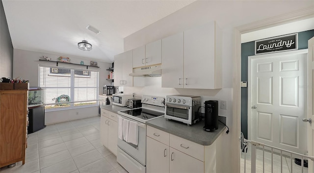 kitchen with white cabinetry, light tile patterned flooring, and white appliances