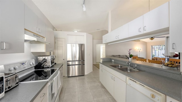 kitchen featuring white cabinets, sink, light tile patterned floors, and stainless steel appliances