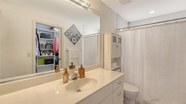 bathroom featuring a shower with curtain, vanity, and toilet