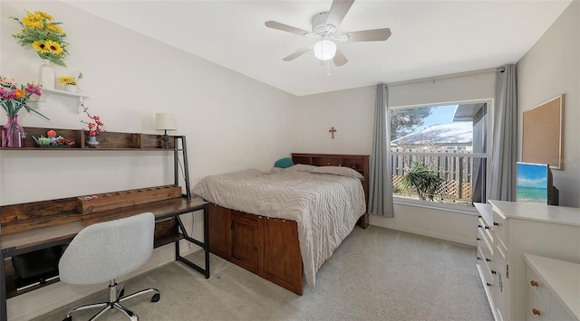 bedroom with ceiling fan and light colored carpet