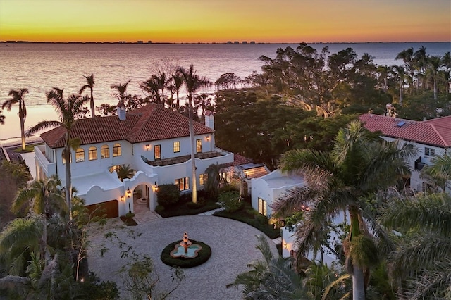 aerial view at dusk with a water view