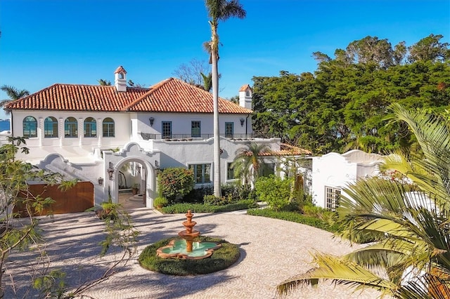 rear view of property featuring a balcony