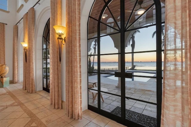 interior space with french doors and a water view