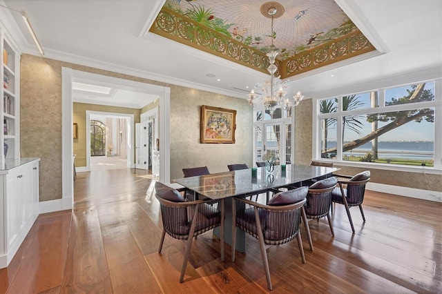 dining area featuring a tray ceiling, crown molding, a water view, and hardwood / wood-style flooring