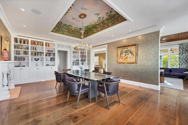 dining area featuring hardwood / wood-style floors, built in features, and crown molding