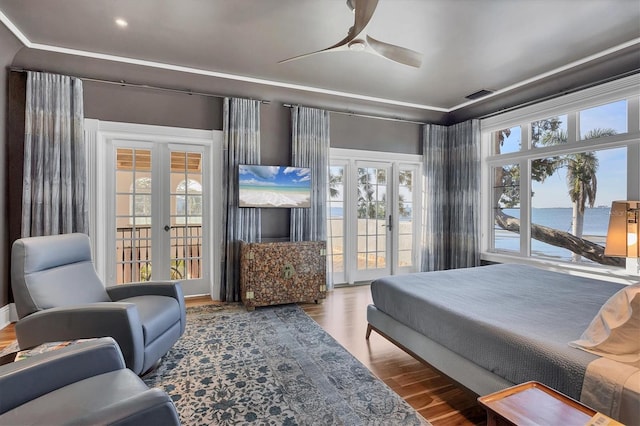 bedroom featuring ceiling fan, access to exterior, wood-type flooring, and french doors