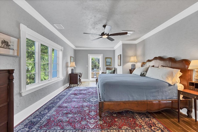 bedroom featuring ceiling fan, hardwood / wood-style floors, a textured ceiling, and ornamental molding