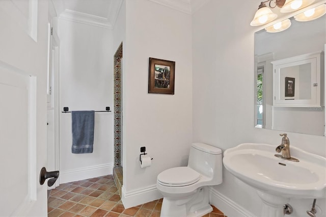 bathroom featuring toilet, ornamental molding, and sink