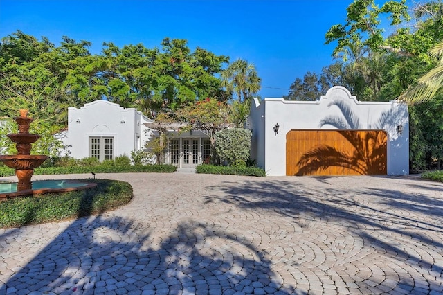 view of front of house with french doors and a garage