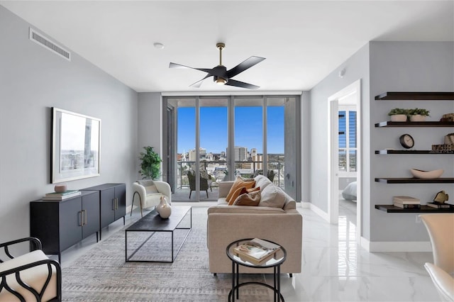 living room featuring expansive windows and ceiling fan