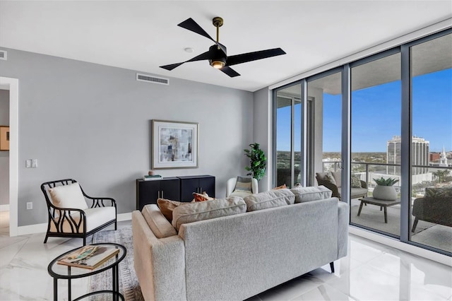 living room featuring floor to ceiling windows and ceiling fan