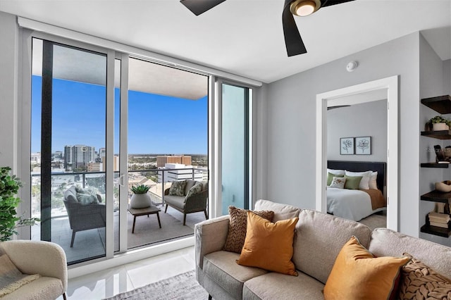 tiled living room with ceiling fan and a wall of windows