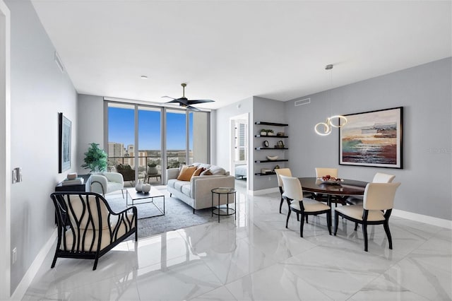 living room with floor to ceiling windows and ceiling fan