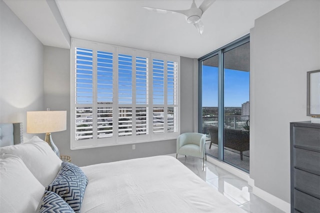 bedroom with access to exterior, ceiling fan, and expansive windows