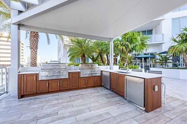 view of patio / terrace featuring exterior kitchen, sink, and grilling area