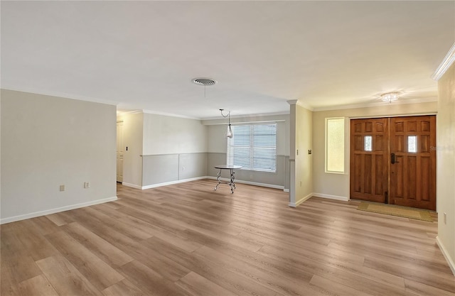 entryway with ornamental molding and light wood-type flooring