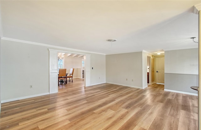 spare room with crown molding and light hardwood / wood-style floors