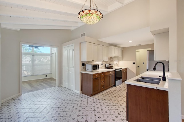 kitchen with pendant lighting, sink, stainless steel electric range, white cabinetry, and dark brown cabinetry