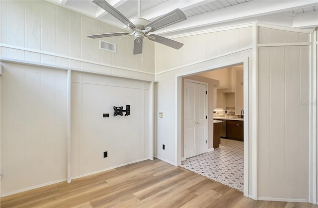 interior space featuring beamed ceiling, ceiling fan, sink, and light hardwood / wood-style floors