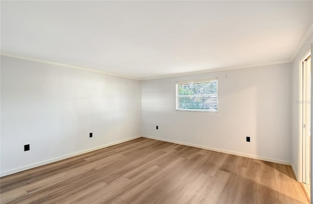 unfurnished room featuring crown molding and light hardwood / wood-style flooring