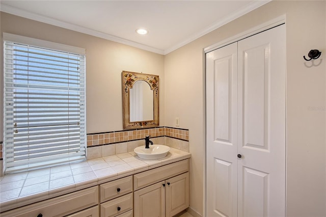 bathroom featuring vanity, crown molding, and decorative backsplash