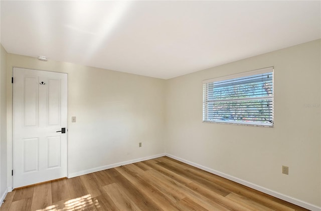 unfurnished room with light hardwood / wood-style floors