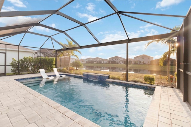 view of swimming pool featuring pool water feature, a water view, a patio area, and a lanai